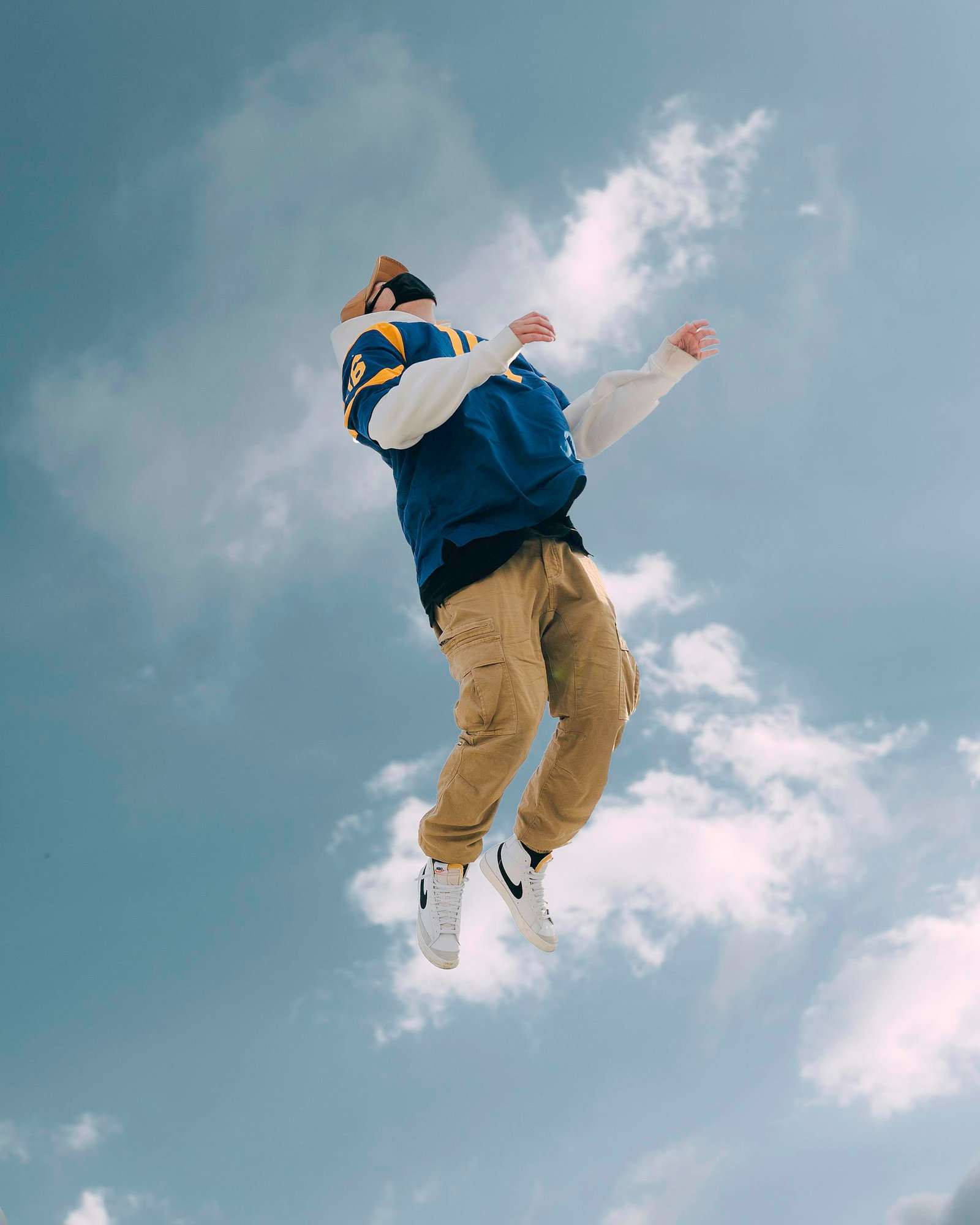 Man jumping outdoors against a blue sky—energy boost from a daily 10-minute exercise routine.