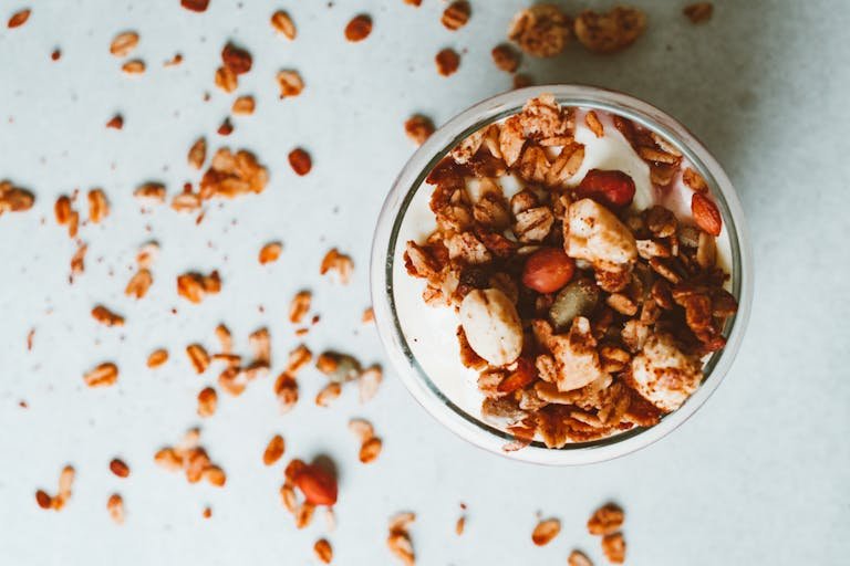 Delicious yogurt parfait topped with crunchy granola and nuts, perfect for a healthy breakfast.